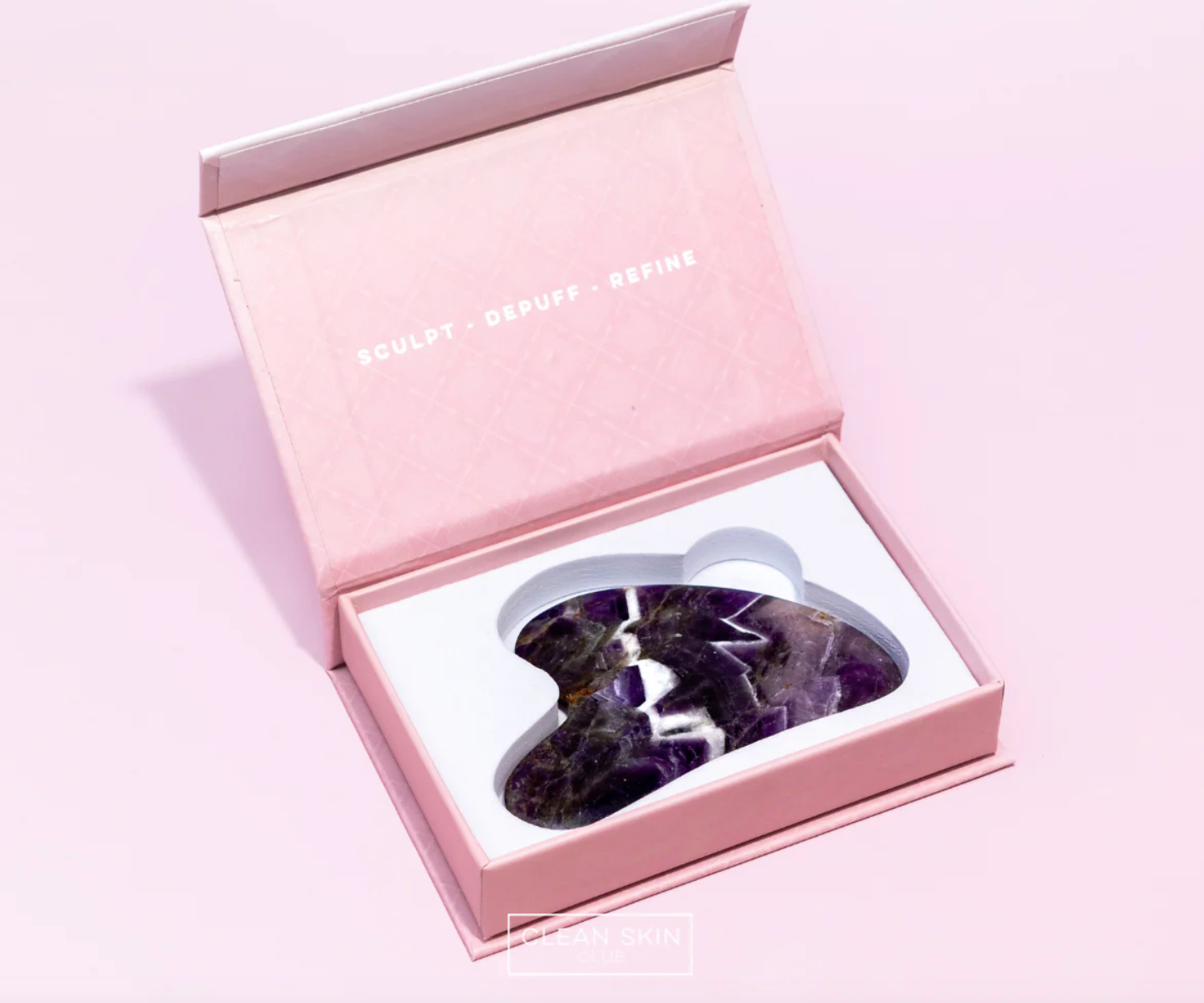 a pink box with a pair of scissors inside of it